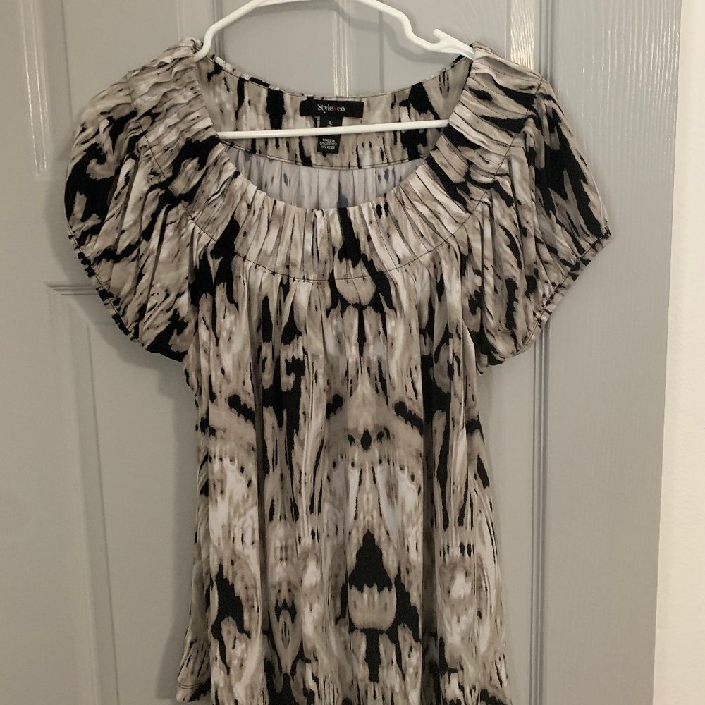 Loose fitting white, cream and black knit blouse